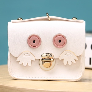 Detail of white owl mini purse showing PU leather texture and metal twist lock closure