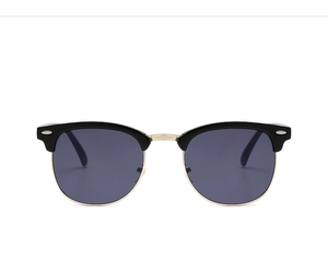 Detail view of semi-rimless sunglasses with black gold frame and dark grey lenses