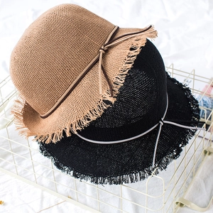 Foldable straw sun hats in black and khaki with fringed edges and delicate bow tie