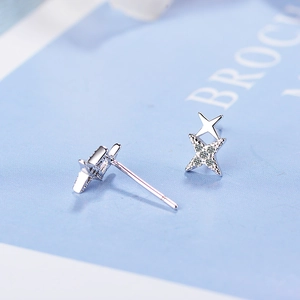 Sparkling silver double star earrings with crystal zircon inlay on blue background