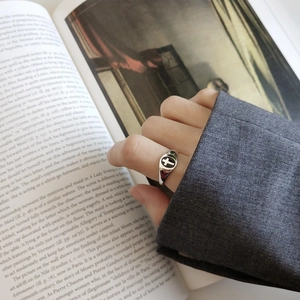 Macro detail of retro 925 sterling silver ring with cross emblem on a vintage book
