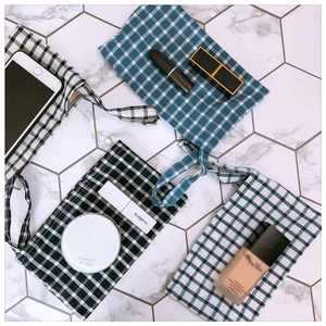 Minimalist checkered fabric pouches in blue and black plaid for phone and coin storage