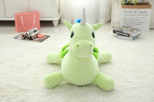 Vue détaillée d'une licorne en peluche verte avec corne argentée dans une chambre