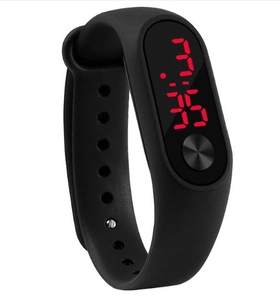 Detail view of the black silicone LED sports watch with red digital display and metal button