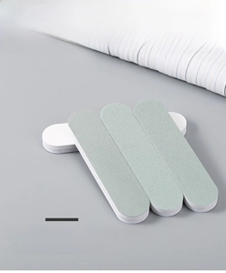 Close-up of dual-sided silver polishing bar showing green grit and white buffing surfaces