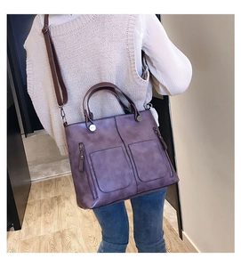 Purple retro tote bag featuring front pockets and adjustable strap on a female model