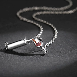 Exquisite silver necklace with wine bottle and red heart zircon pendant in macro view