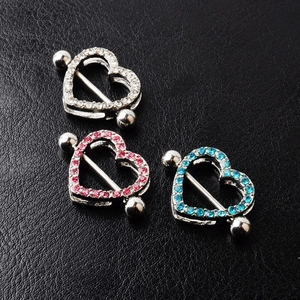 Detail shot of heart-shaped nipple shields with crystals in white, pink, and blue