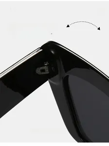 Detail shot of durable reinforced metal hinges on black oversized cat-eye sunglasses