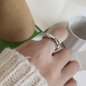 Minimalist 925 sterling silver ring with polished finish on a casual lifestyle background