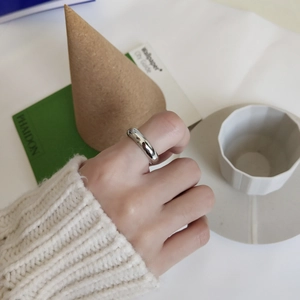 Minimalist 925 sterling silver ring shown on hand in a stylish modern lifestyle setting