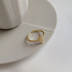 Detail of 925 silver gold ring with diamond pattern and shimmering cubic zirconia