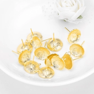 Macro shot of gold-plated earring posts with cup bases for DIY jewelry making