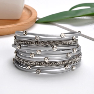 Detailed macro view of multi-layer silver-gray bracelet with rhinestone accents and magnetic clasp