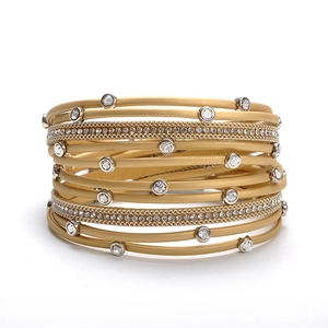Detailed macro view of multi-layer golden leather bracelet with crystal rhinestone inlay