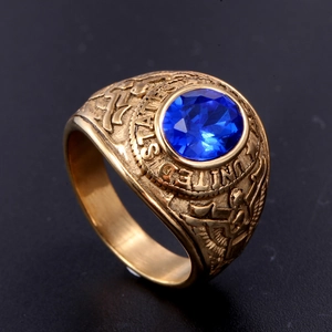 Macro view of golden stainless steel eagle ring with large blue round gemstone