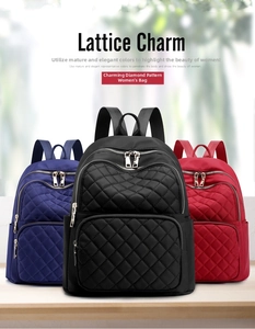 Close-up of lattice pattern nylon backpacks in navy, black and red with zipper detail