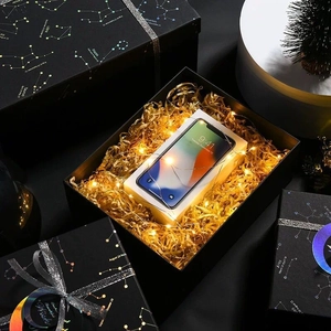 Elegant black gift box with zodiac patterns, LED lights, and raffia paper filler