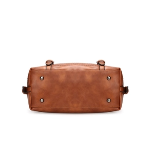 Bottom view of brown leather Boston bag showing four protective metal feet on white background