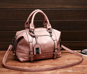 Close-up of pink PU leather Boston bag showing fine texture and FASHION BAG logo