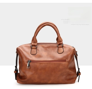 Detailed back view of a vintage brown leather Boston bag featuring a silver zippered pocket