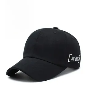 Detail of black cotton baseball cap showing 'THE MOST' embroidery and side metal ring