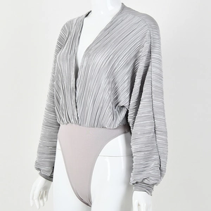 Detail view of silver V-neck pleated jumpsuit with lantern sleeves on model