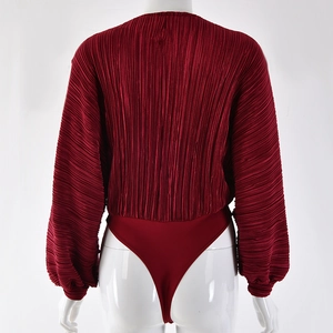 Macro detail of wine red pleated fabric texture on long sleeve jumpsuit back view