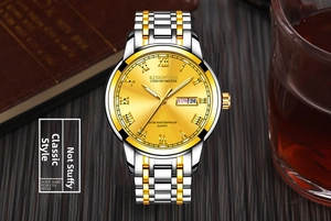 Detail of two-tone steel watch with day-date display and 3ATM waterproof mark