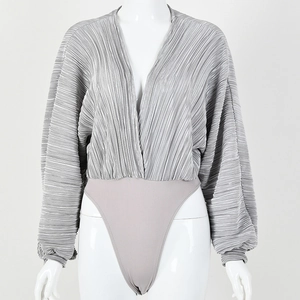 Detail of grey pleated metallic fabric with deep V-neck and long lantern sleeves