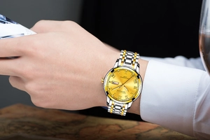 Detailed close-up of KIRDUDS watch with dual calendar display and gold Roman numerals