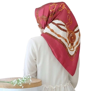 Detail of burgundy silk square scarf with gold chains and horsebit equestrian pattern