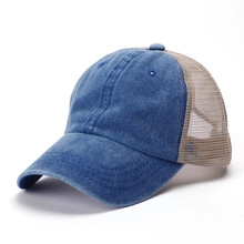 Detail of classic baseball cap featuring blue denim brim and breathable beige mesh back