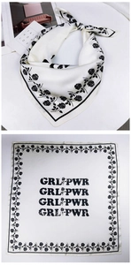 Detail of satin square scarf featuring black rose patterns and Girl Power slogan print