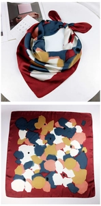Detail of artistic square scarf with abstract color block print and silky texture