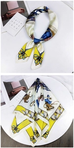 Detail of printed silk scarf featuring classic horsebit pattern in yellow and blue