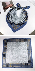 Detail view showing blue geometric plaid silk scarf with artistic ink splash pattern