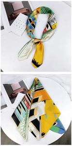 Close-up of vibrant geometric print satin scarf featuring abstract color block patterns