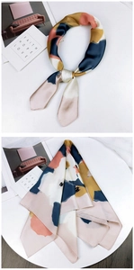 Detail of silk scarf with pink and blue abstract watercolor patterns on white background