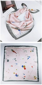 Detailed flat lay of pink silk scarf featuring Eiffel Tower and French lifestyle illustrations