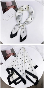 Detail of silk scarf featuring camellia floral patterns and black polka dot border