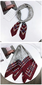 Detail of silk scarf with geometric diamond pattern and abstract gray spot textures