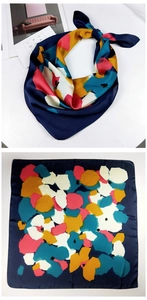 Detail of navy blue silk-feel scarf with abstract floral print and satin finish