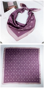 Macro detail of purple silk scarf with white camellia pattern and elegant satin luster