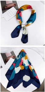 Detail of artistic satin silk scarf with abstract geometric patterns and smooth texture