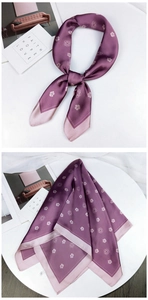 Detail of purple camellia floral silk scarf with smooth satin texture and elegant drape