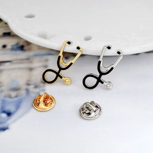 Creative stethoscope brooches in gold and silver finish with black enamel detailing