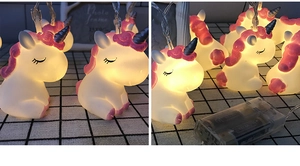 Detail of unicorn LED string lights with warm white glow and transparent battery box