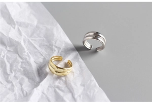Minimalist double-layered gold and silver rings with reflective polished finish