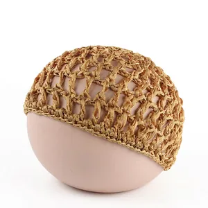 Detail view of a gold-brown handmade crochet hairnet with intricate mesh texture